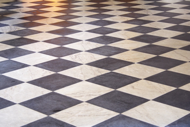 Square floor tiles are portrayed in a diagonal pattern.  Alternating tiles are black and white.